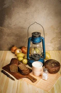 The pot of milk, rye bread, a cutting board, salt and salt salt, onions Stock Photos