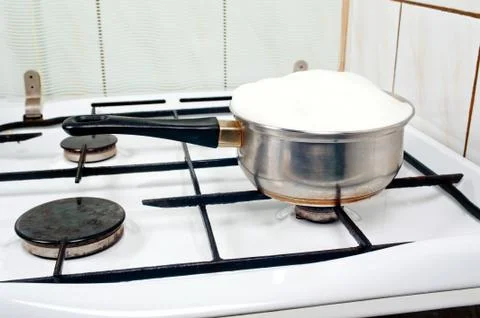 Pot of a over boiling milk Stock Photos