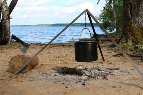 The pot over the fire and axe in log Stock Photos