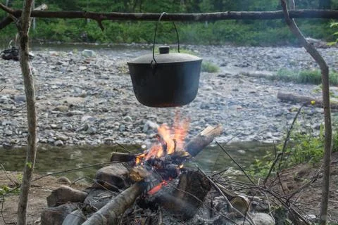 Pot over a fire in the forest Stock Photos