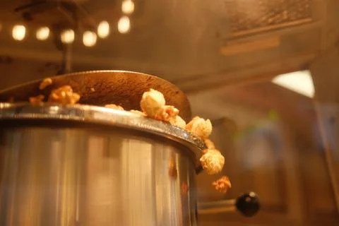 A pot of popcorn is being cooked in a machine Stock Photos