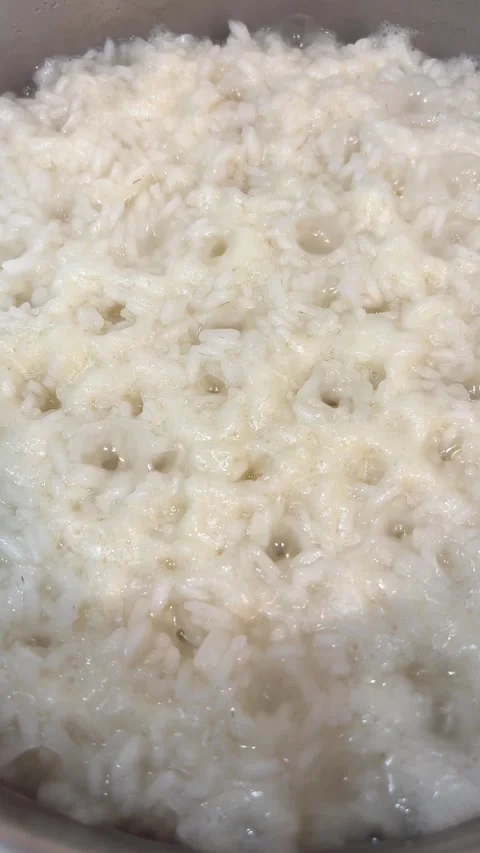 A pot of rice is boiling on a stove Stock Footage 297600972