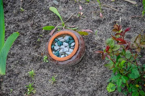 A pot of rubble peeks out of the ground Stock Photos