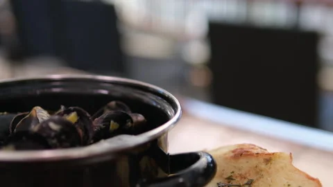 Pot with shellfish mussels Cooked mussels in a pot. Seafood, toasts and lemon. Stock Footage 295146275