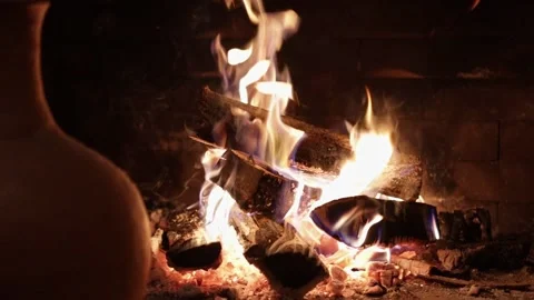 Pot sitting on a fireplace with a fire in the background and a fire in the Stock Footage 230558526