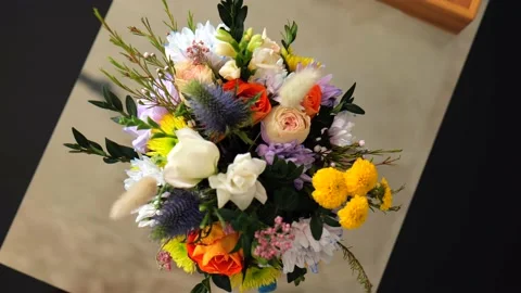 A pot of spring flowers on the kitchen table. multi - colored flowers Stock Footage 219454603