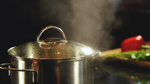 Pot on the stove  boiling, and the chef uncover the lid Stock Footage 100615800