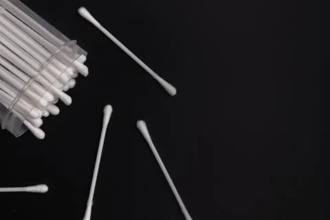 A pot of swabs placed on a dark surface. Hygiene article on people. Stock Photos
