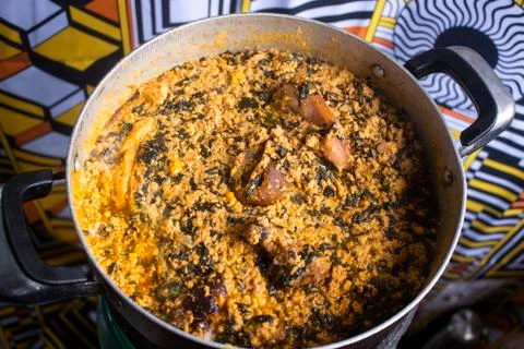 A pot of tasty Egusi soup cooked with assorted meat and dried fish Stock Photos