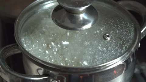 Pot in which water boils is covered with transparent lid. Stock Footage 198570588