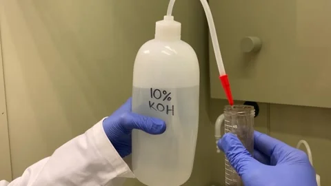 Potassium Hydroxide being poured into test tube Stock Footage 315761440