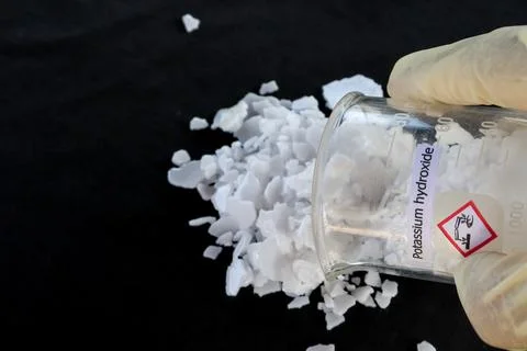 Potassium hydroxide flake on black background Fotos Stock