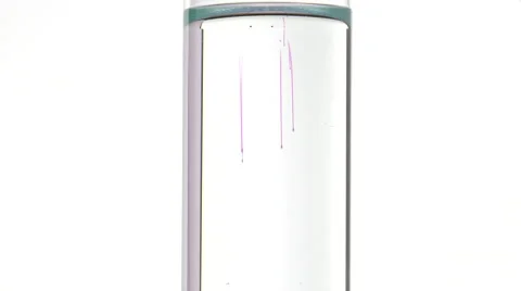 Potassium permanganate fall in water of a test tube Video stock 64291031