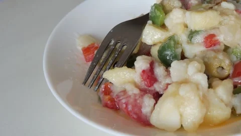 Potato and vegetable colourful summer salad. Raw onion, peppers, and olives Stock Footage 343454106