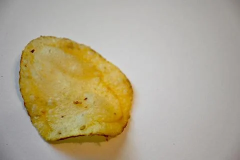 Potato Chip Close-Up on White Background, Minimal Snack Food Concept Fotos Stock