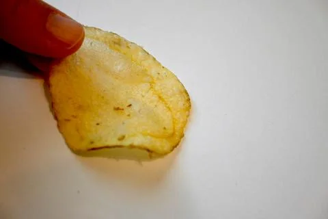 Potato Chip in Hand Close-Up, Snack Food and Eating Concept Photos