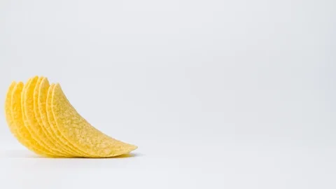 Potato chips appear on a white background. A stack of chips. Snack. 4k. Stop Stock Footage 88825981