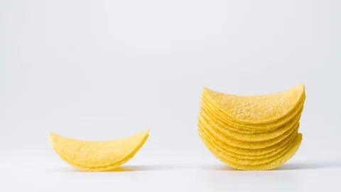 Potato chips are moving on a white background. A stack of chips. Snack. 4k. Stop Stock Footage 88825796