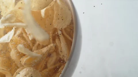 Potato chips in a bowl falling. Slow Motion. Stock Footage 89612161