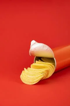 Potato chips in bright red background Stock Photos