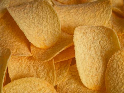 Potato chips close-up in direct sunlight - top view Stock Photos