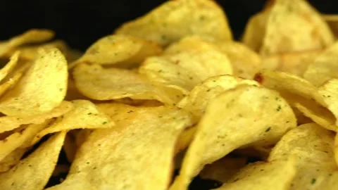 Potato chips on a dark background Video stock 229561429