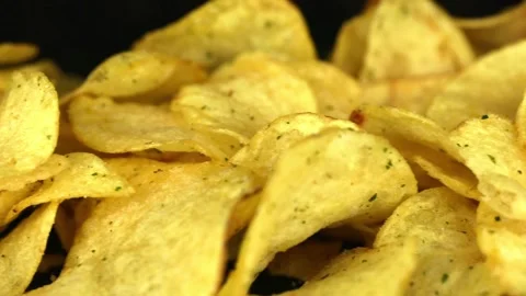 Potato chips on a dark background Video stock 229724934