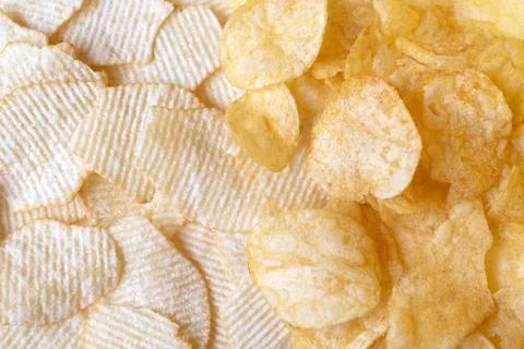 Potato chips exture background top view. Crispy snack, junk food, fastfood Stock Photos