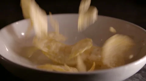 Potato Chips Falling into Bowl Stock Footage 53029299