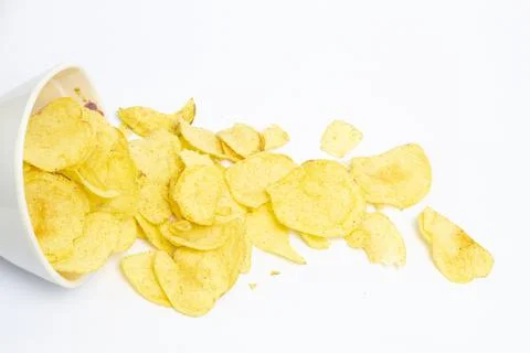 Potato chips falling into bowl isolated on white background Stock Photos