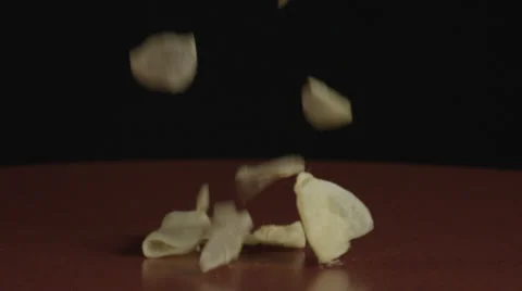 Potato chips falling in slow motion on table top 库存影片 32272639
