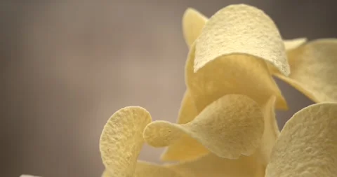 Potato chips flying in slow motion 1000 fps against blue background Stock Footage 344848966