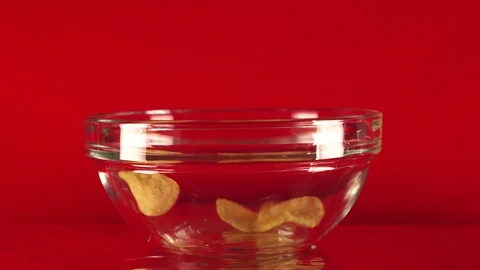 Potato chips in free fall in a cup. The hand takes a cup with chips Stock Footage 88299131