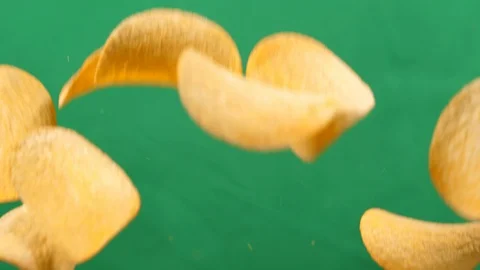 Potato chips in free fall on a green background. Slow motion. Pringles Stock Footage 127916709