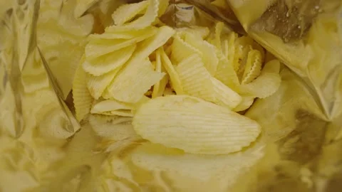 Potato chips inside plastic bag, unhealthy food. Stock Footage 235339958