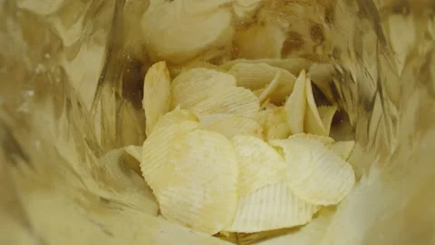 Potato chips inside plastic bag, unhealthy food. Stock Footage 235340009