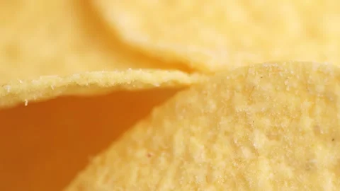 Potato chips macro view, rotation. Crispy potato rotating close up. Golden .. Stock Footage 257585875