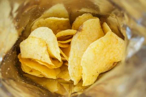 Potato chips in an open bag Stock Photos