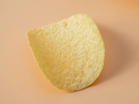 Potato chips on an orange background. Close-up. Stock Photos