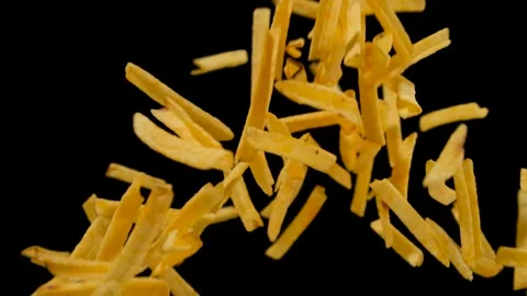Potato chips. Potato chips fall on a black background. Close up Stock Footage 135469296