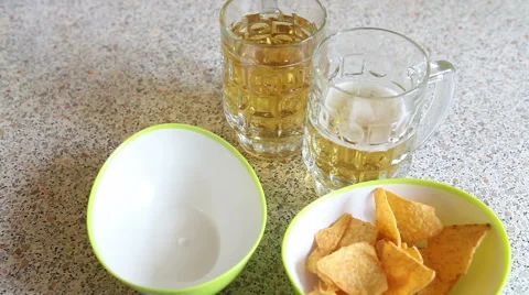 Potato chips poured into the cup. snack to beer Stock Footage 60397281
