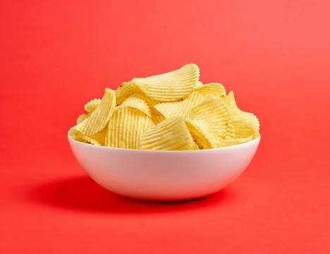 Potato chips on red background Stock Photos