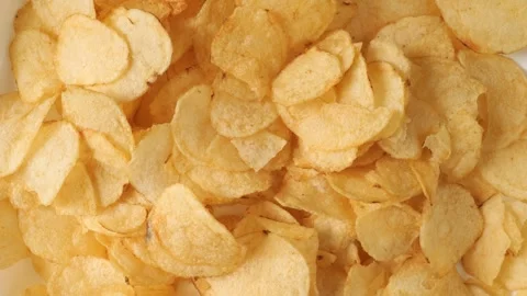 Potato chips rotating creating a food background Video stock 335559963
