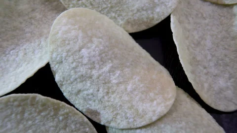 Potato Chips Rotating in Macro View, Textured Curved Surface Stock Footage 345610548