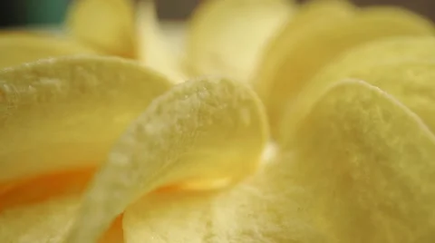 Potato chips on a rotating plate, close up video Stock Footage 55756923