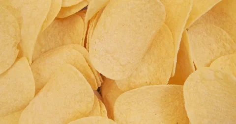 Potato chips rotating, stop motion, close-up, top view. Background for unhealthy 動画素材 283764689