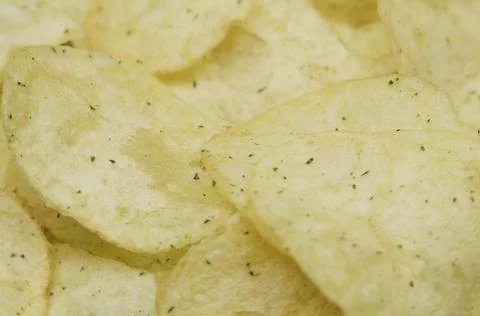 Potato chips on a rotating surface. Close-up. Fotos Stock
