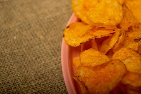 Potato chips on a round platter. Close up. Stock Photos