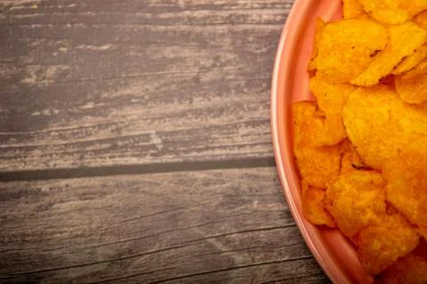 Potato chips on a round platter. Close up. Stock Photos