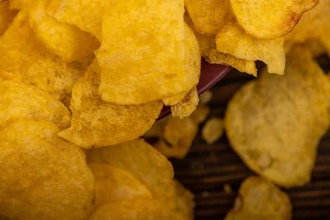 Potato chips scattered on the table, close-up, selective focus. Stock Photos